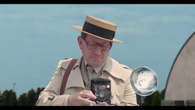 Video Reference: Glasses, Hat, Sun hat, Flash photography, Vision care, Photographer, Dress shirt, Reflex camera, Camera lens, Eyewear