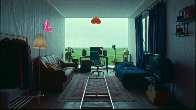 Video Reference: Property, Furniture, Building, Chair, Picture frame, Floor, Living room, Table, Plant, Tints and shades