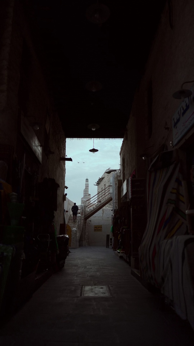 Video Reference: Sky, Road surface, Alley, Building, Road, Tints and shades, Art, Flooring, City, Darkness