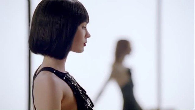 Video Reference: woman, side profile, bob haircut, black dress, portrait, fashion, blurred background, indoor, elegant, studio, profile, silhouette