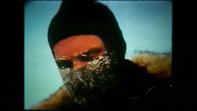 Video Reference: close-up, person, winter, cold, frost, snow, hood, fur coat, outdoors, low resolution, face covered, seasonal clothing