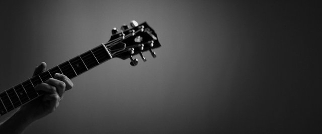 Video Reference: guitar, music, musician, instrument, close-up, black-and-white, hand, strings, performance, artistic, blurred background, neck, frets, acoustic guitar, electric guitar