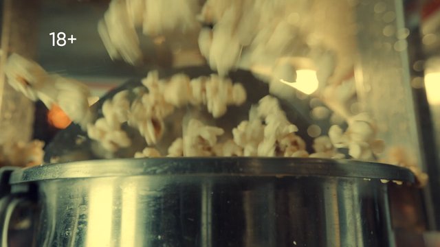 Video Reference: popcorn, popcorn machine, snack, food, pouring, movie theater, kitchen, close-up, motion blur, warm light, glass, metal, 18 plus, indoor, preparation