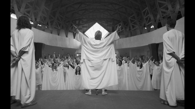 Video Reference: White, Black, Sleeve, Black-and-white, Gesture, Entertainment, Style, Performing arts, Headgear, Fashion design