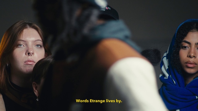 Video Reference: Eyebrow, Flash photography, Cap, Black hair, Helmet, Hat, Elbow, Event, Thigh, Midnight