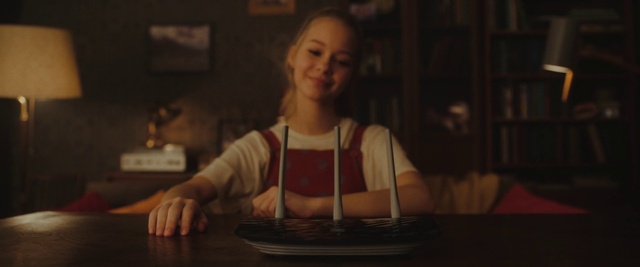 Video Reference: Smile, Flash photography, Table, Wood, Music, Musical instrument accessory, Fun, Darkness, T-shirt, Event