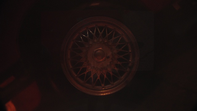 Video Reference: Brown, Automotive tire, Gas, Automotive lighting, Rim, Circle, Spoke, Darkness, Pattern, Engineering