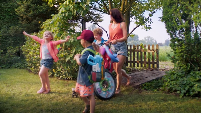 Video Reference: Wheel, Plant, Tire, Shorts, People in nature, Tree, Happy, Sunlight, Outdoor recreation, Grass