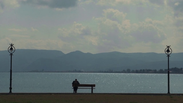 Video Reference: Water, Cloud, Sky, Mountain, Lake, Horizon, Bench, Tints and shades, Landscape, Mountain range