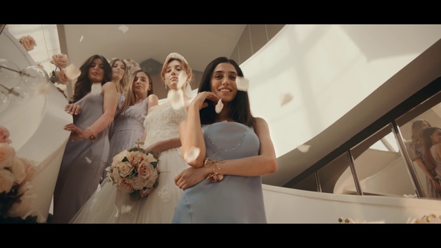 Video Reference: Smile, Wedding dress, Shoulder, Bride, Dress, Flower, Flash photography, Bridal party dress, Bridal clothing, Happy