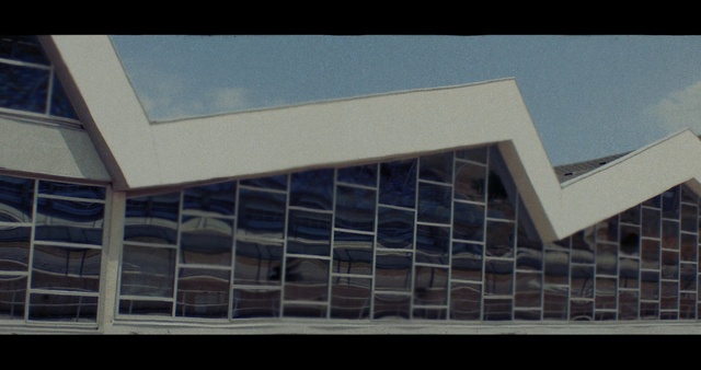 Video Reference: Sky, Rectangle, Shade, Urban design, Facade, Font, Composite material, Building, Commercial building, Tints and shades