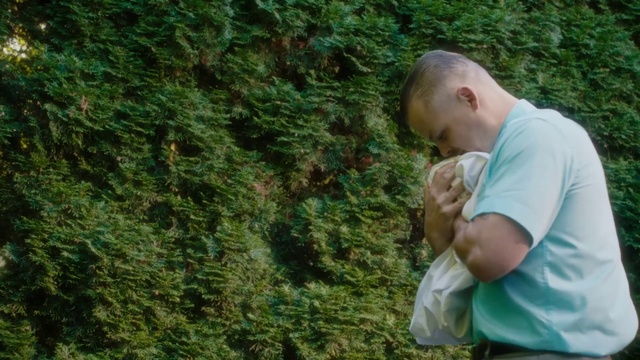 Video Reference: People in nature, Terrestrial plant, Grass, Groundcover, Grass family, Wood, Evergreen, Forest, T-shirt, Shrub