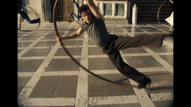 Video Reference: man, action, motion blur, jumping, spinning, rope, courtyard, outdoor, dance, martial arts, tile floor, dynamic, group, historic building, exercise