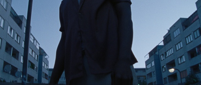 Video Reference: Sky, Window, Building, Sleeve, Grey, Blazer, Electric blue, City, Human leg, Magenta