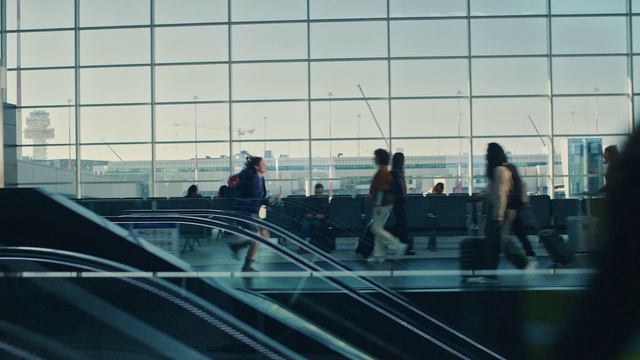Video Reference: Sky, Building, City, Tints and shades, Escalator, Glass, Symmetry, Urban area, Human settlement, Stairs