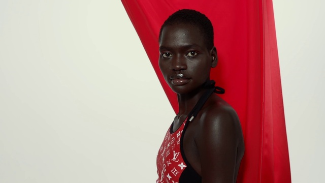 Video Reference: Lip, Hairstyle, Black hair, Fashion design, Art, Magenta, Street fashion, Event, Jewellery, Fictional character