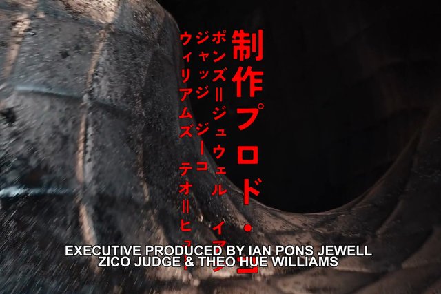 Video Reference: tunnel, pipe, dark interior, close-up, texture, Japanese text, credits, title card, overlay text, abstract, industrial, curved surface, red text, white text, video frame