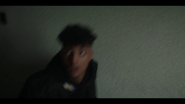 Video Reference: Flash photography, Jaw, Gesture, Tints and shades, Facial hair, Font, Midnight, Cap, Darkness, Room