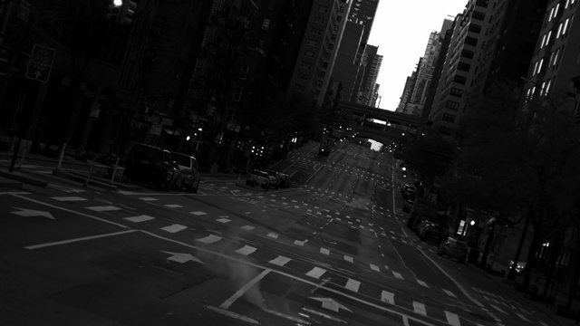 Video Reference: Building, Sky, Road surface, Car, Mode of transport, Street light, Black-and-white, Thoroughfare, Road, Midnight