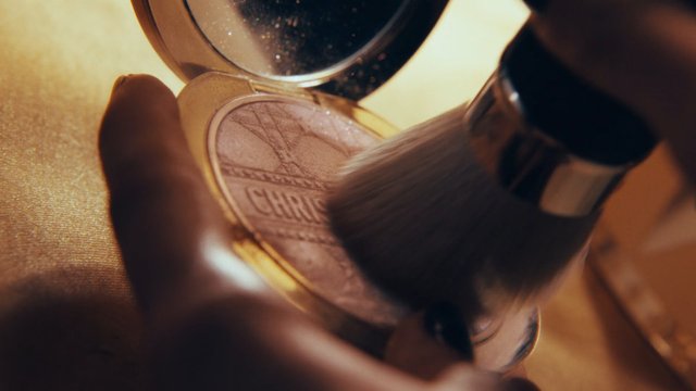 Video Reference: makeup, cosmetics, powder, brush, compact, palette, beauty, close-up, golden light, macro, application, fashion, skincare, grooming