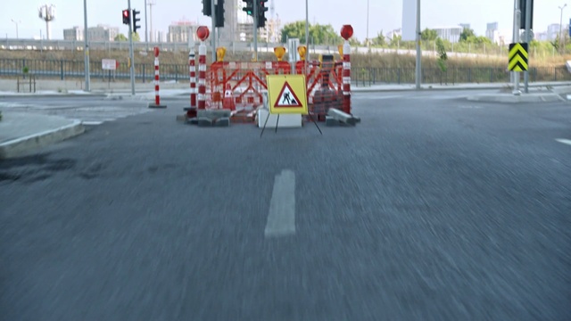 Video Reference: Road surface, Asphalt, Traffic sign, Motor vehicle, Tar, Vehicle, Sidewalk, Road, Gas, Barricade