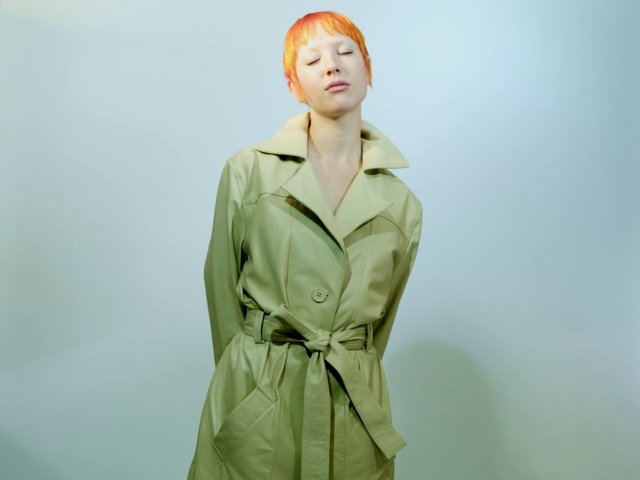 Video Reference: Face, Outerwear, Arm, Human body, Neck, Sleeve, Flash photography, One-piece garment, Dress, Gesture