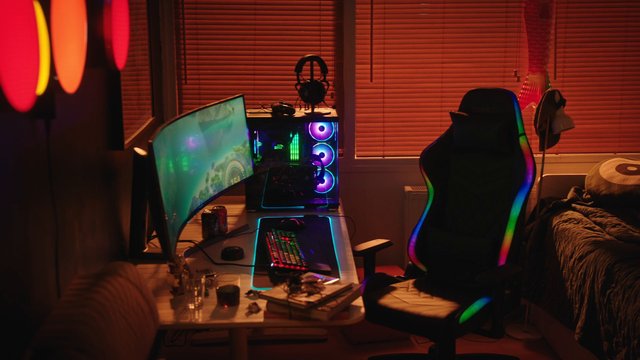 Video Reference: gaming room, desktop computer, curved monitor, RGB lights, gaming chair, keyboard, PC setup, workstation, headphones, indoor, desk, bedroom, neon lighting, electronics, home office, ambient light