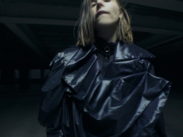 Video Reference: Hair, Lip, Flash photography, Sleeve, Street fashion, Leather jacket, Fashion design, Eyewear, Long hair, Electric blue