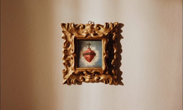 Video Reference: religious art, framed painting, ornate frame, gold frame, wall decor, sacred heart, cross, interior, still life, beige wall, home decor, vintage style