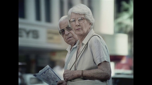 Video Reference: Glasses, Vision care, Eyewear, Street fashion, Hat, Event, City, Wrinkle, Street, Road