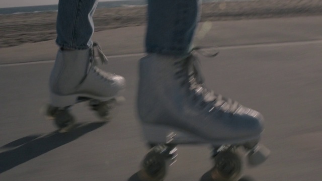 Video Reference: Jeans, Knee, Outdoor shoe, Thigh, Roller skates, Grey, Rolling, Sports equipment, Calf, Street fashion