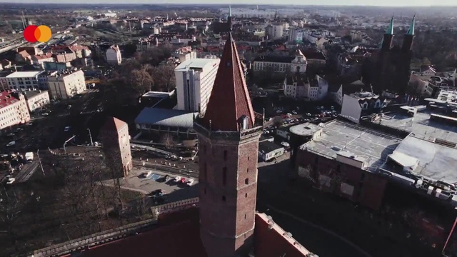 Video Reference: Sky, Building, Tower, Tower block, Urban design, Cityscape, Public space, Landscape, Neighbourhood, Roof
