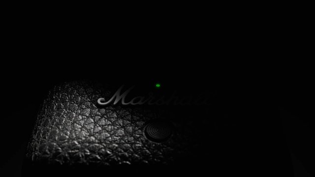 Video Reference: dark, close-up, textured surface, device, logo, indicator light, black, low light, abstract, electronics