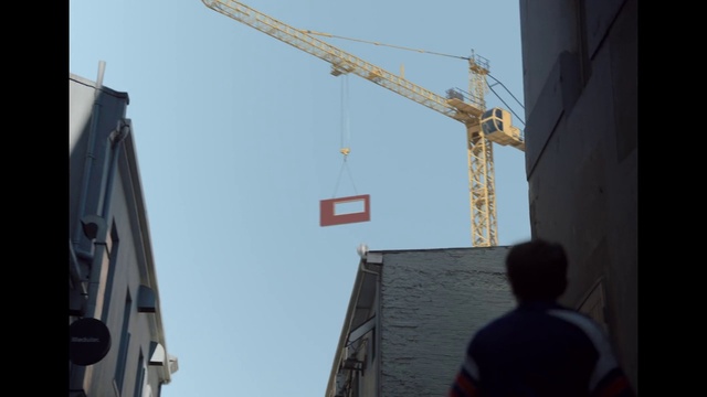 Video Reference: Sky, Building, Line, Composite material, Crane, Facade, Window, City, Electricity, Roof