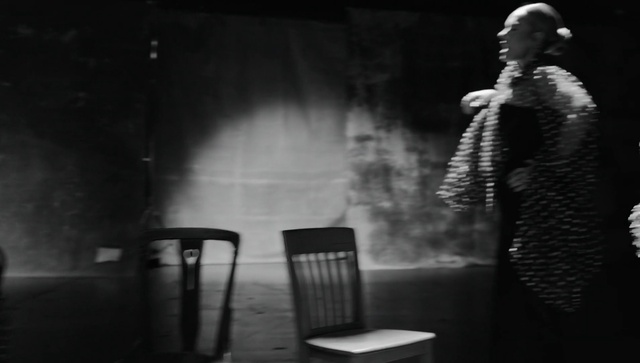 Video Reference: Flash photography, Entertainment, Standing, Grey, Style, Chair, Black-and-white, Performing arts, Monochrome, Event