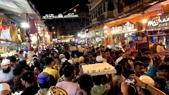 Video Reference: Shirt, Yellow, Customer, Crowd, T-shirt, Community, Hat, Market, City, Event