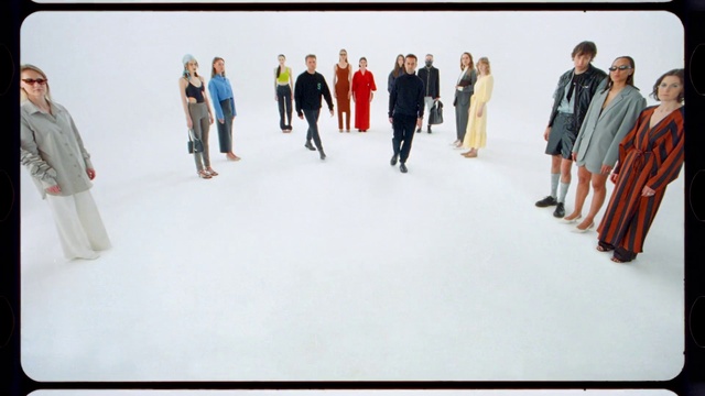 Video Reference: Sleeve, Gesture, Automotive design, Art, Font, Fashion design, Event, Workwear, Formal wear, Electric blue