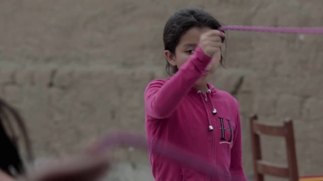 Video Reference: Sleeve, Magenta, Leisure, Recreation, Fun, Audio equipment, Grass, Event, Child, Jewellery