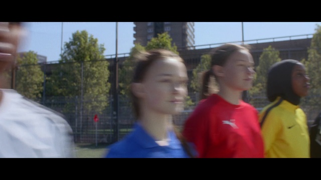 Video Reference: Shoulder, Standing, Happy, Tree, Leisure, T-shirt, Grass, Public space, Recreation, Event
