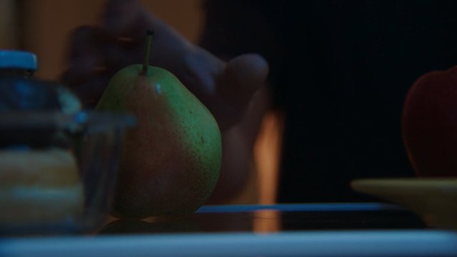 Video Reference: pear, fruit, close-up, still life, table, dim lighting, blurred background, food, indoor, moody, macro, fresh produce