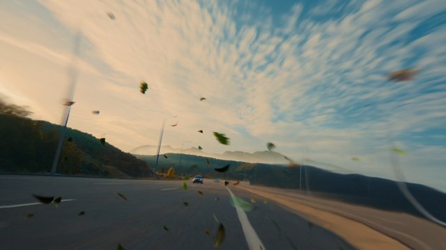 Video Reference: highway, road, mountains, sky, clouds, car, motion blur, outdoor, travel, landscape, driving, nature, evening light, debris, wind