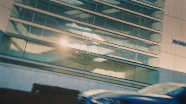 Video Reference: Hood, Building, Blue, Window, Automotive lighting, Shade, Motor vehicle, Street light, Glass, Automotive exterior