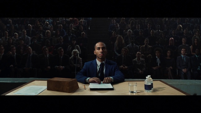Video Reference: Table, Furniture, Microphone, Coat, Suit, Chair, Spokesperson, Tie, Bottle, Desk