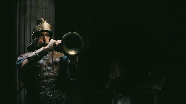 Video Reference: person, armor, helmet, trumpet, horn, roman, costume, historical, music, dark, indoor, drama, theater, performer