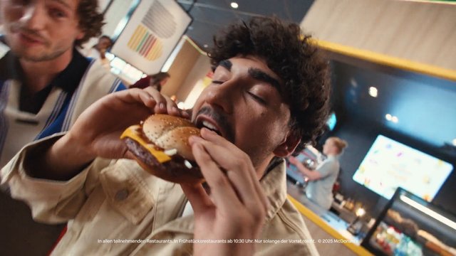 Video Reference: fast food, restaurant, burger, cheeseburger, eating, young men, indoor, counter, casual dining, commercial, advertisement, people, snack, lunch, interior, close-up