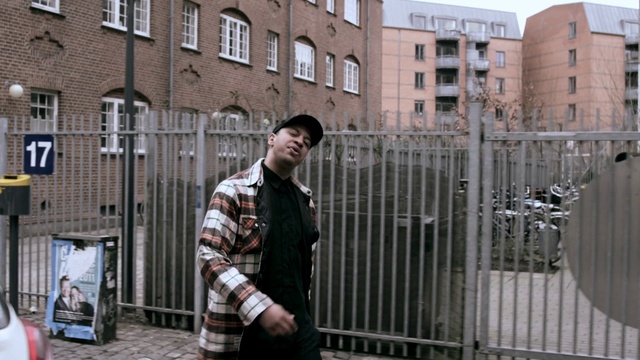 Video Reference: Building, Window, Tartan, Sleeve, Fence, Architecture, Street fashion, Sky, Travel, City