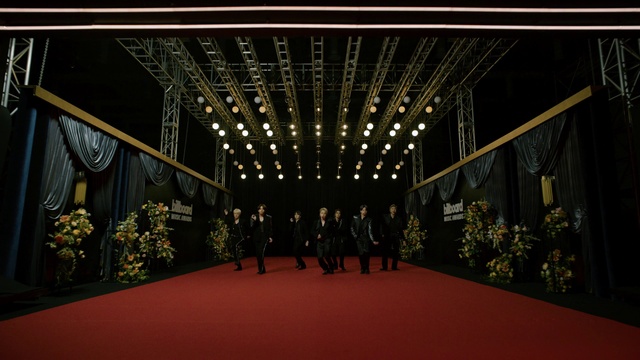 Video Reference: Plant, Dress, Building, Flooring, Symmetry, Event, Red carpet, Art, Suit, Formal wear