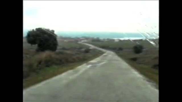 Video Reference: road, coast, landscape, rural, paved road, sea, hills, grassland, curve, outdoors, travel, empty road