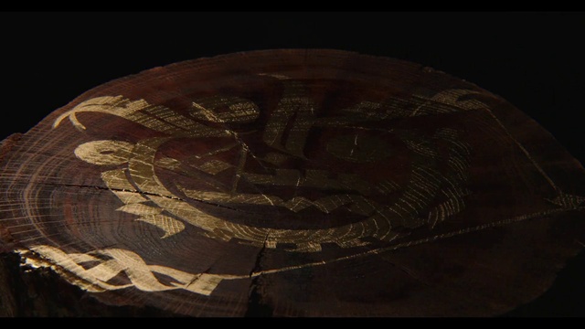 Video Reference: Brown, Artifact, Art, Wood, Tints and shades, Circle, Font, Darkness, Pattern, Visual arts