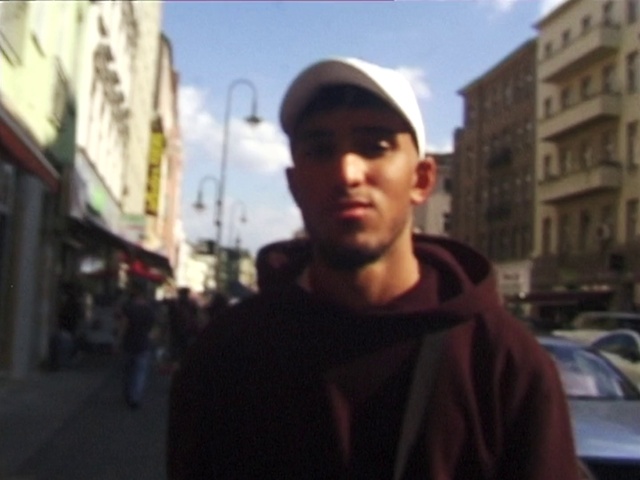 Video Reference: Cloud, Sky, Building, Cap, Street fashion, Hat, Travel, Headgear, Cool, Public space